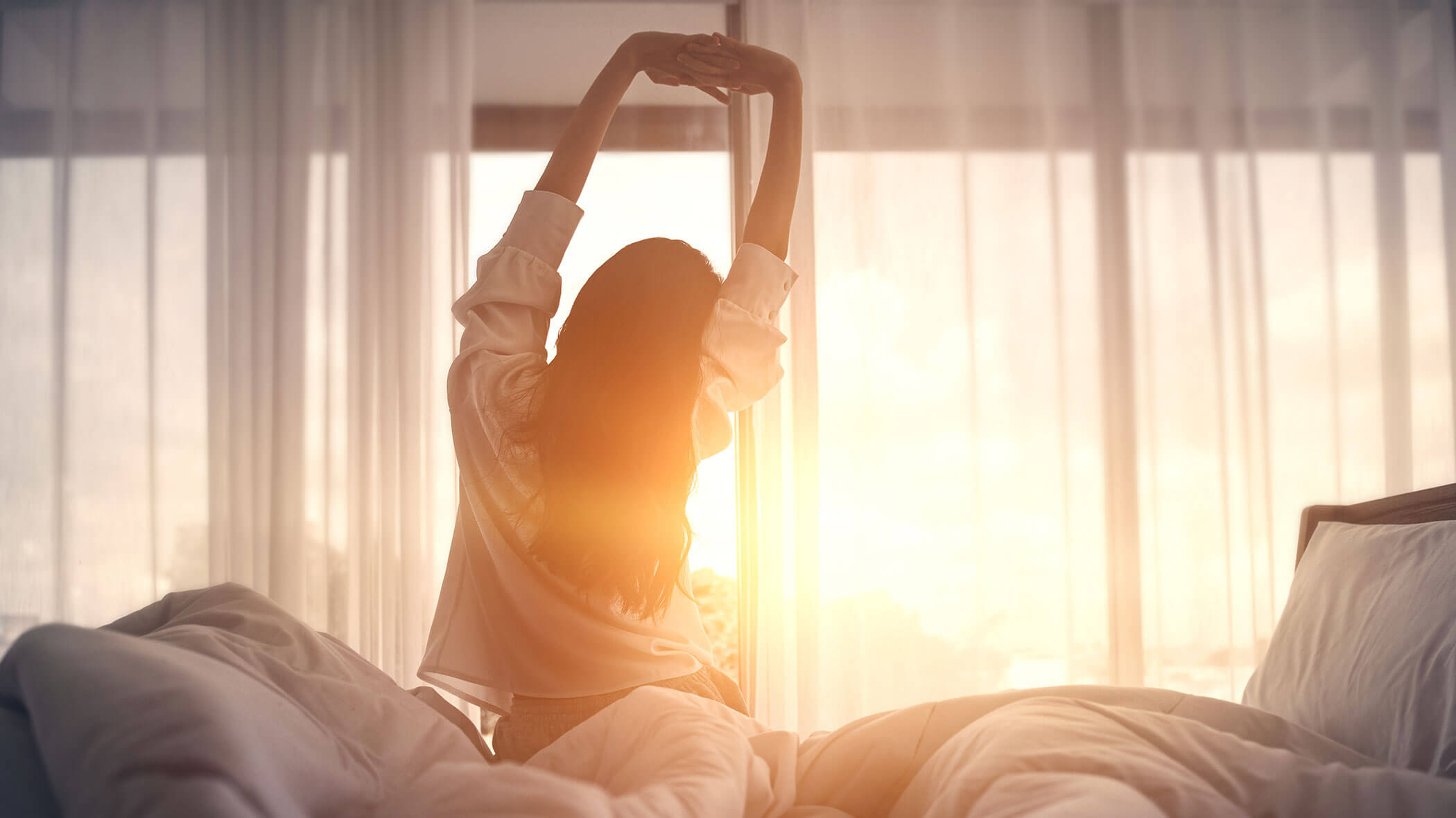 Woman stretches after waking up - Zin Park Residence